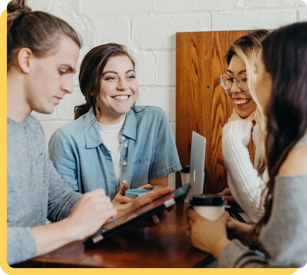 Colleagues talking together around a table during a workplace wellness session