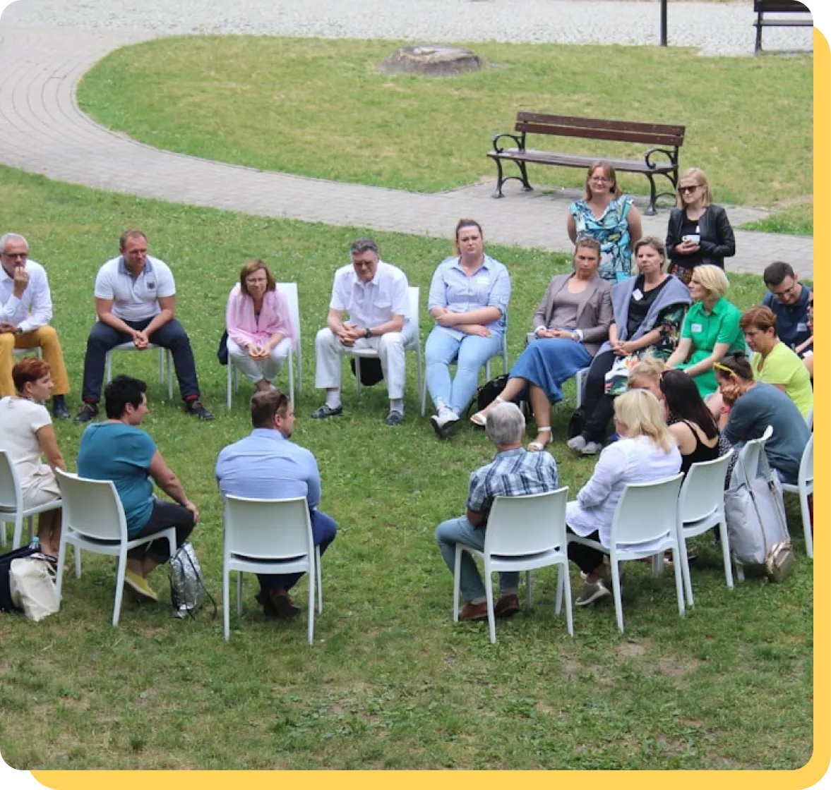 A group seated in a circle during a facilitator-led session