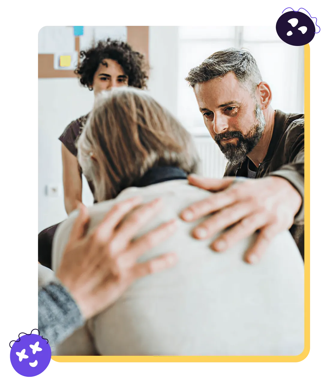 A therapist comforting a group member during a support session
